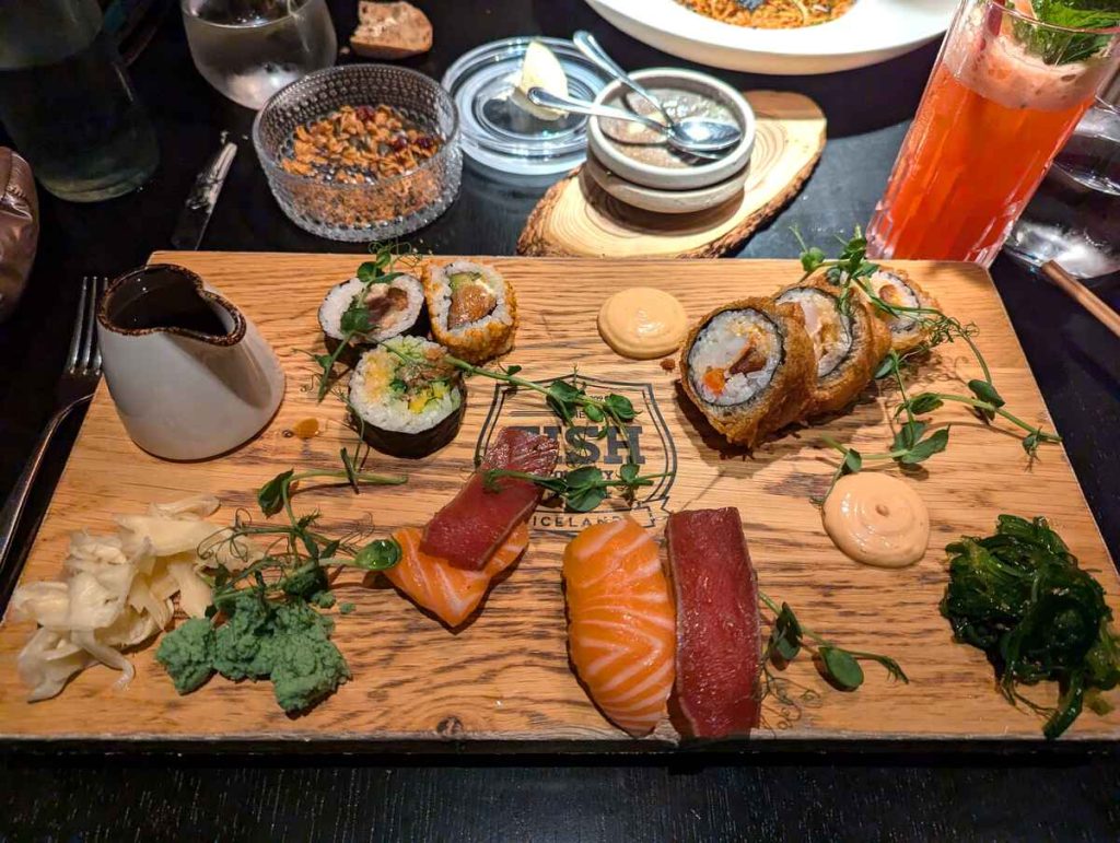 A wooden platter with different types of sushi
